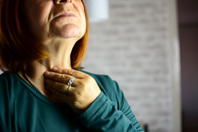 woman holding thyroid gland