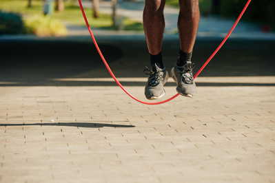 close up of man's legs jumping rope