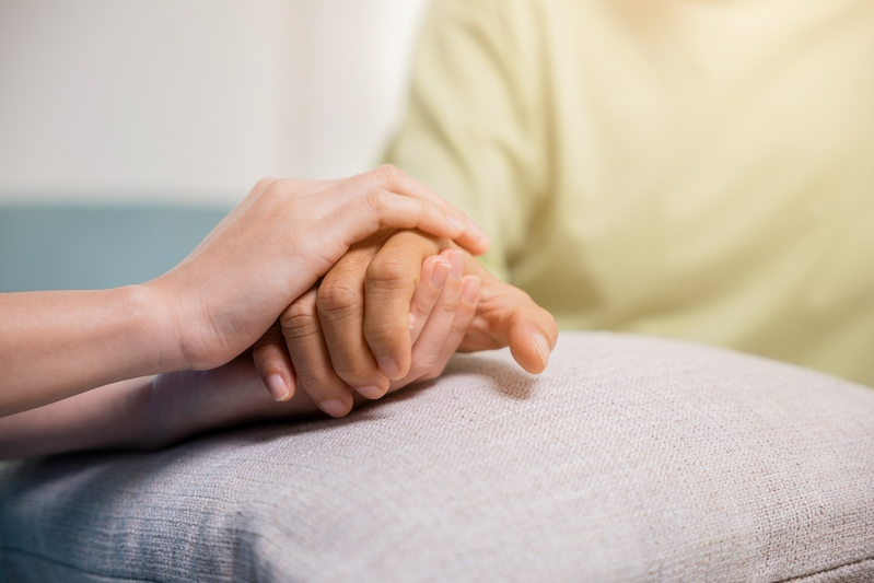 holding hands with elderly patient