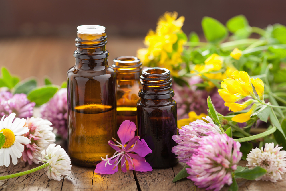 essential oils surrounded by flowers