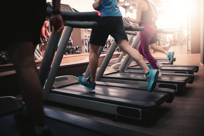 people running on treadmills in a gym